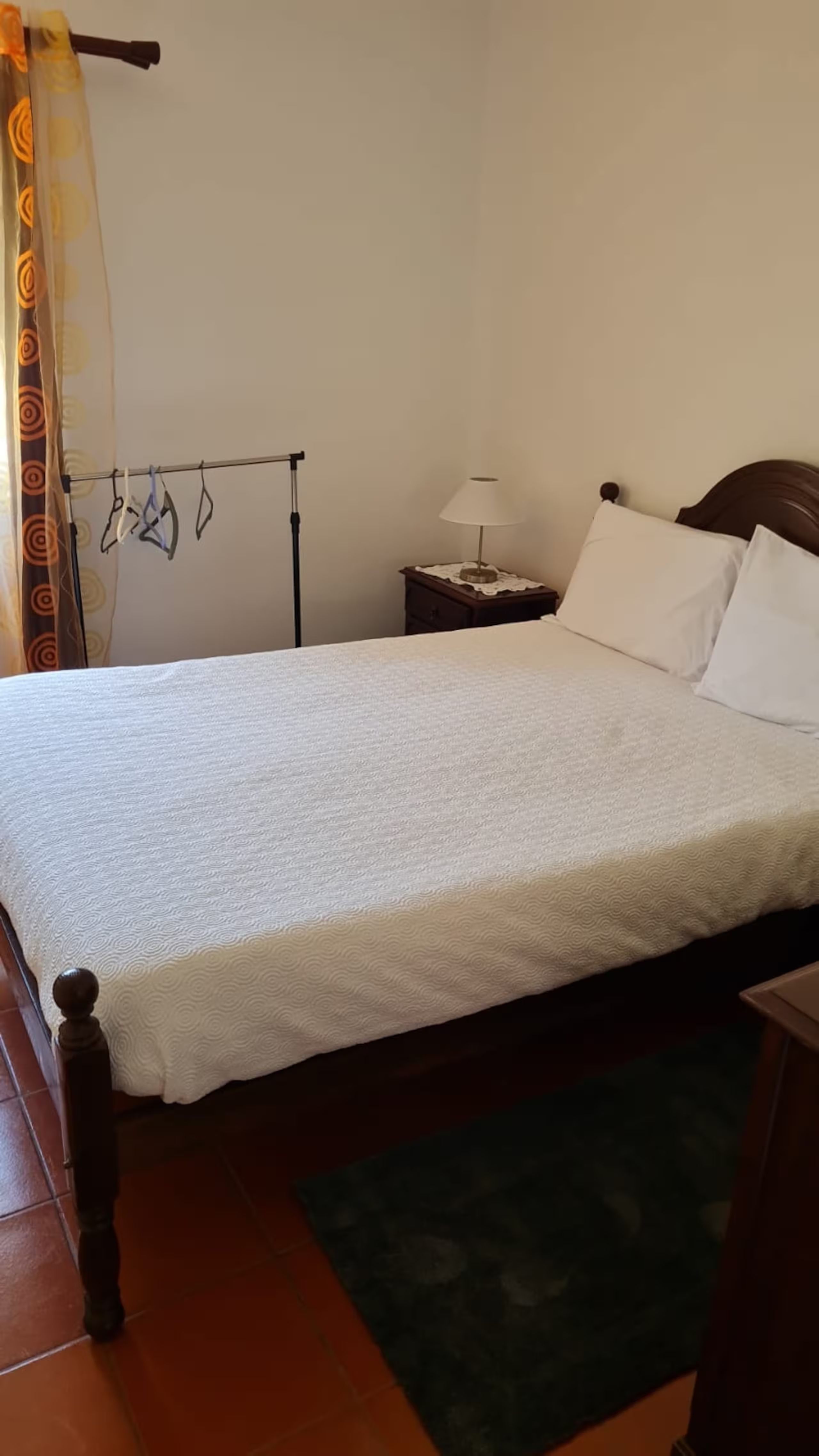 Bedroom 3, queen bed with bedside lamp and a hanging rail